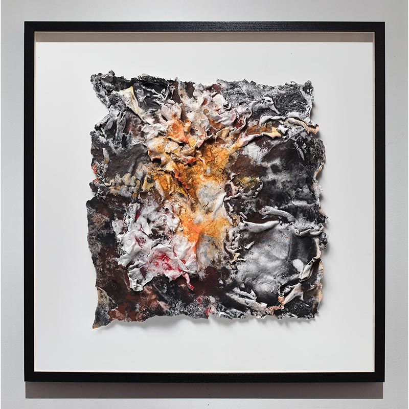 Framed abstract textural work on paper. Mainly orange and black colors. Title: Flammae Tenebrosae