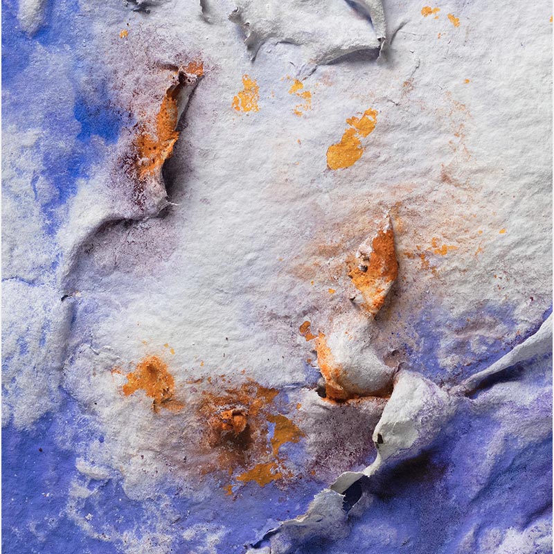 Detail of an abstract textural work on paper. Mainly blue and orange colors. Title: Lumina Brumalis