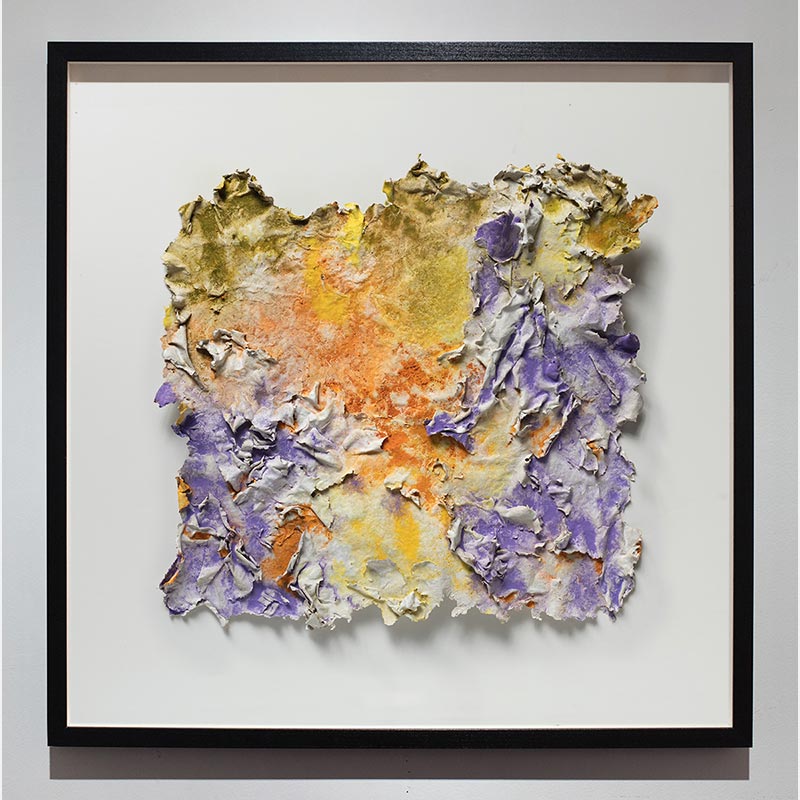Framed abstract textural work on paper. Mainly yellow, orange, and purple colors. Title: Solstitium