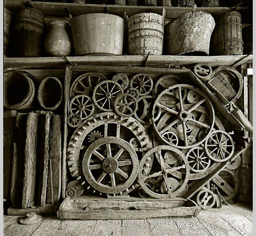 Color Photograph of wooden wheels at the Museo Ettore Guatelli, Ozzano Taro Collecchio, Parma, Italy. Limited edition print. Title: Still Life with Wooden Wheel