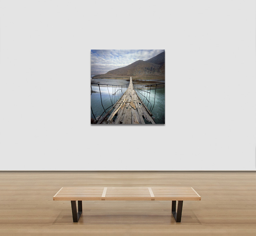 View in a room of a Color Photograph of a wooden bridge in Peru. Limited edition print. Title: Tropics Before the Engine: Wooden Bridge, Peru