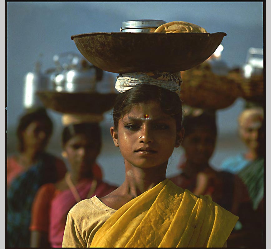 Color Photograph of a Young Lady carrying a vessel over her head, limited edition print. Title: Tropics Before the Engine: Young Women Carring a Vessel on their Head, Madurai, India