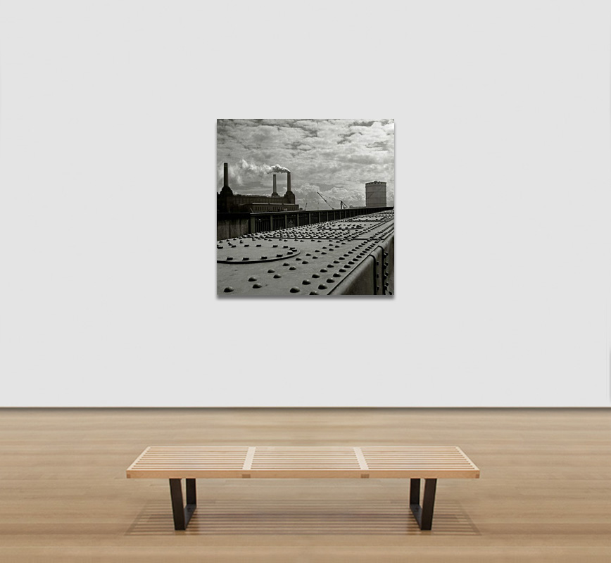View in a room of a Black and white photograph of an industrial site in London during the 1950s. Limited edition print into a circle. Title: Untitled