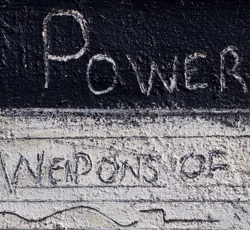 Detail of a highly textural black and white painting with political statements written in sgraffito. Title: Black and White