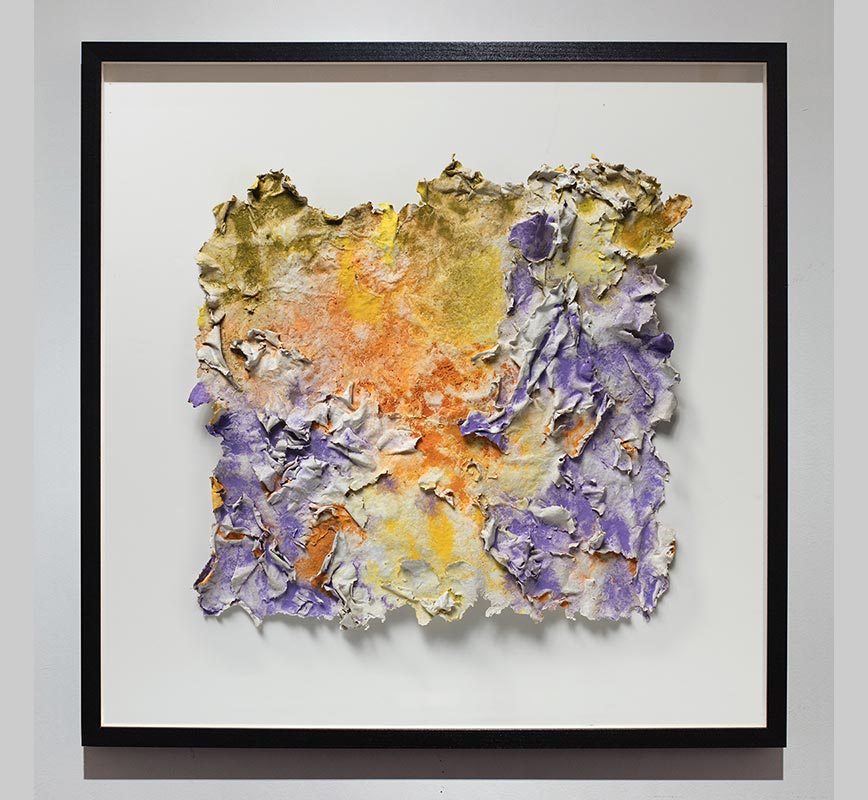 Framed abstract textural work on paper. Mainly yellow, orange, and purple colors. Title: Solstitium (Summer Solstice)