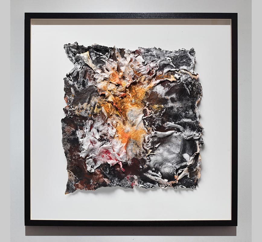 Framed abstract textural work on paper. Mainly orange and black colors. Title: Flammae Tenebrosae (Fires in the Darkness)