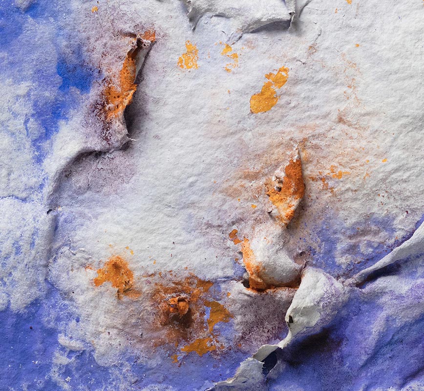 Detail of an abstract textural work on paper. Mainly blue and orange colors. Title: Lumina Brumalis (Winter Lights)