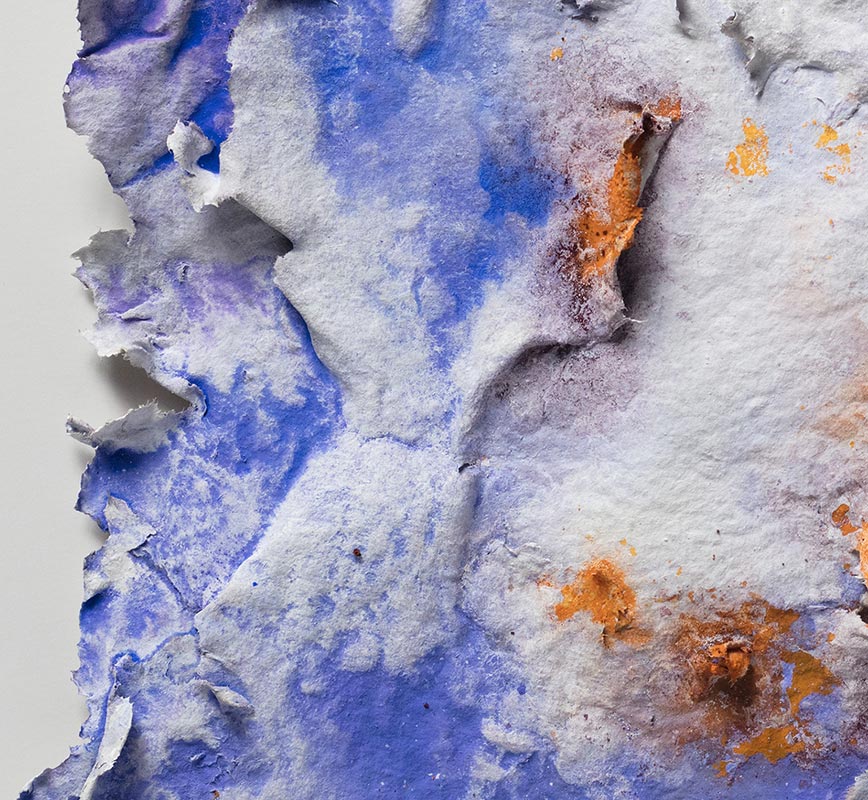 Detail of an abstract textural work on paper. Mainly blue and orange colors. Title: Lumina Brumalis (Winter Lights)